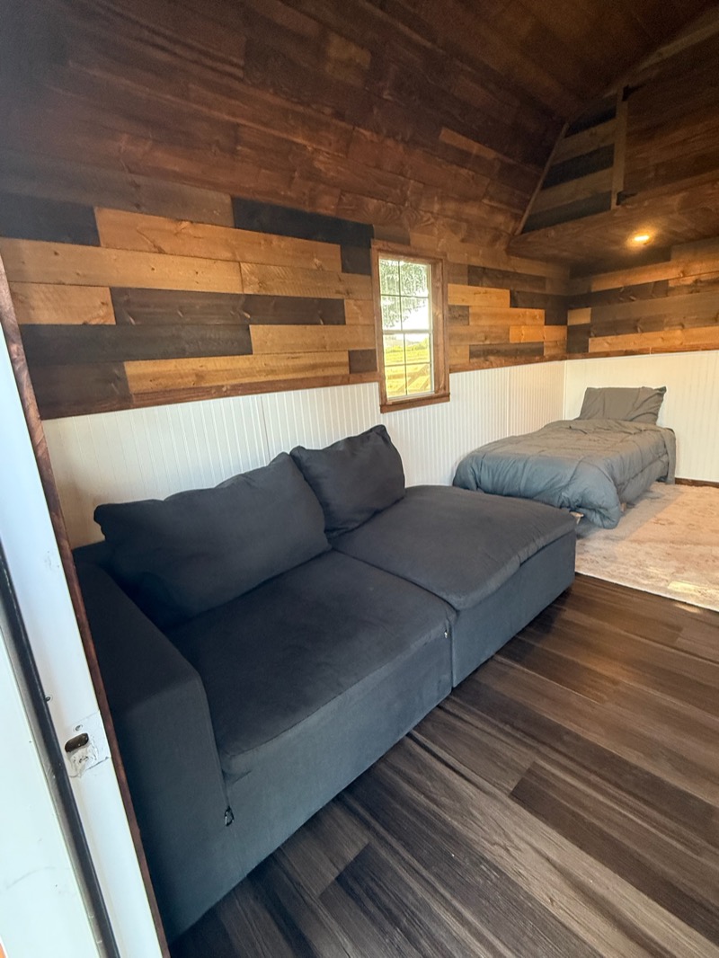 Rustic wood cabin with couch and bed